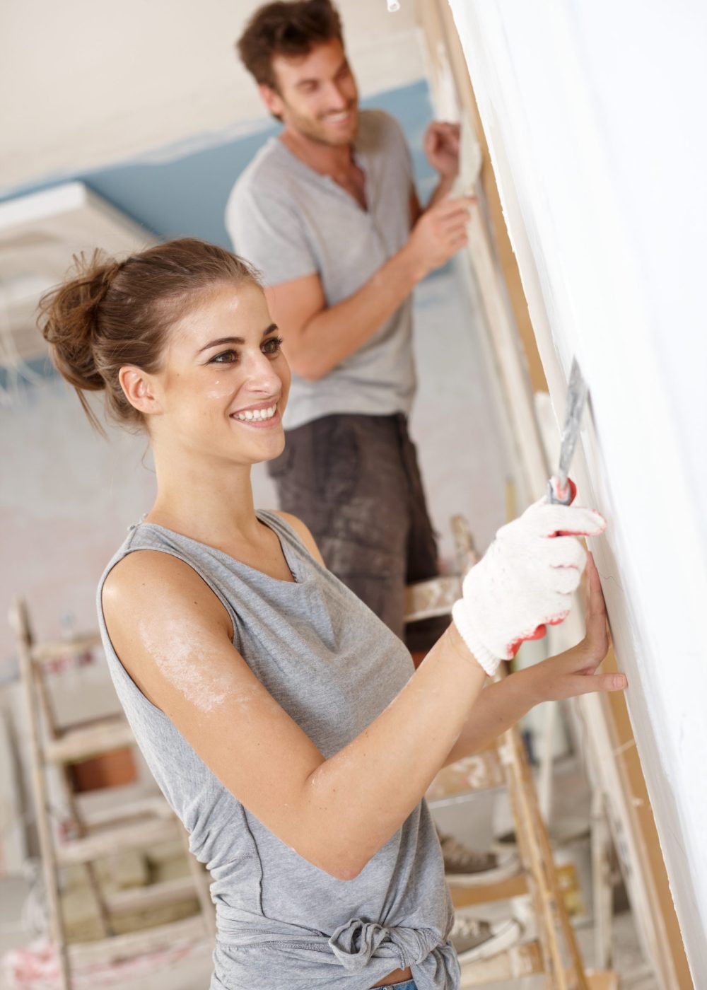 Happy young woman working on flat renovation, smiling..